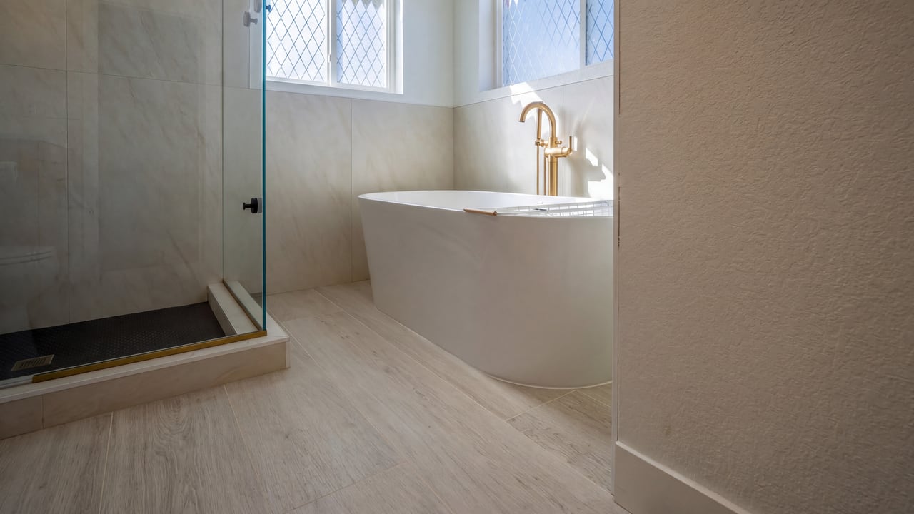 Freestanding bathtub beside a glass-enclosed shower
