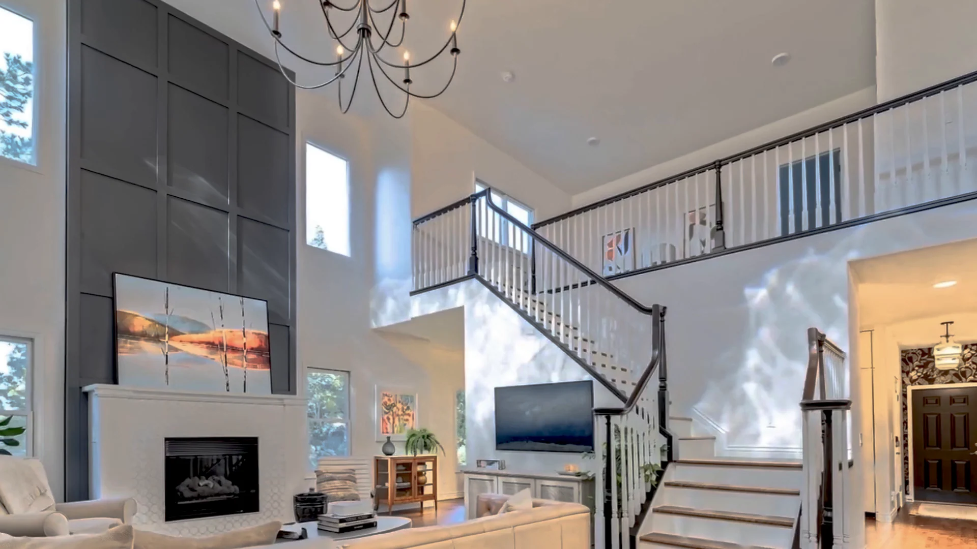 Light-filled living room with a sculptural staircase and fireplace