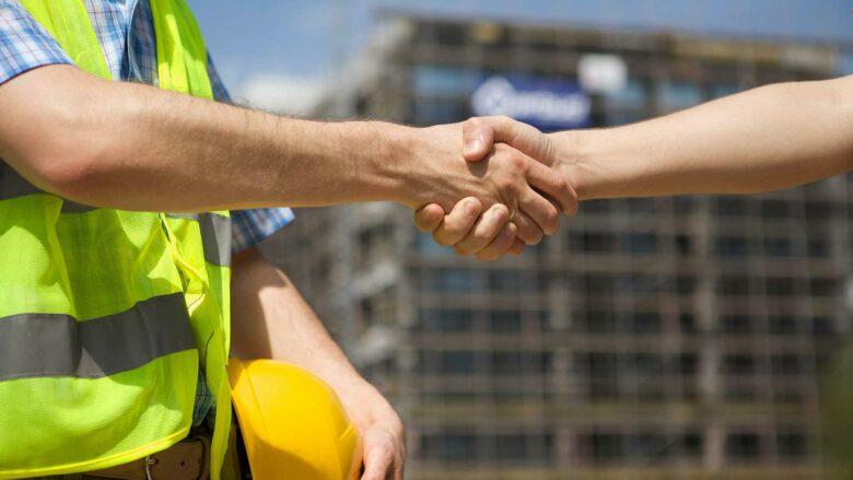 General contractor shaking hands with client in Lakewood, CO