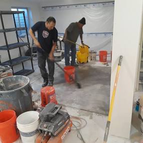 Construction Company workers preparing concrete floors