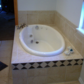 Deep soaker tub installed after bathroom renovations in Denver